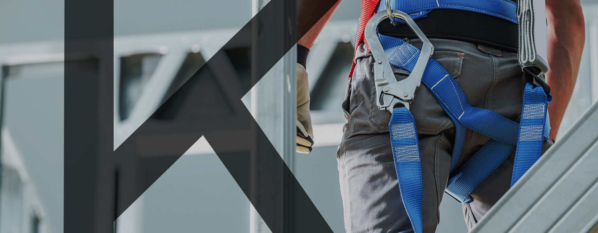 Construction-worker-wearing-a-harness-to-work-on-heights-with-Khusela-letter-K-overlay-Darker